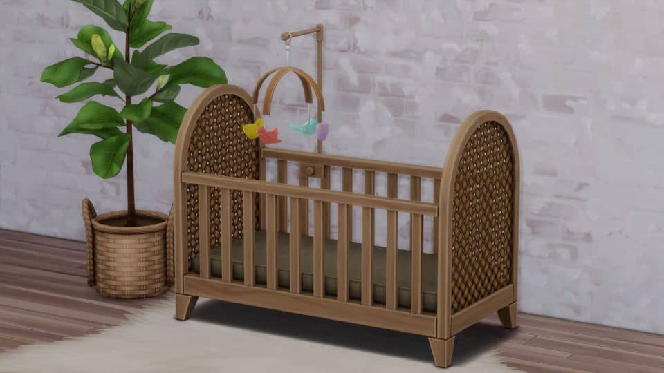 rattan-styled crib with colored-bird mobile