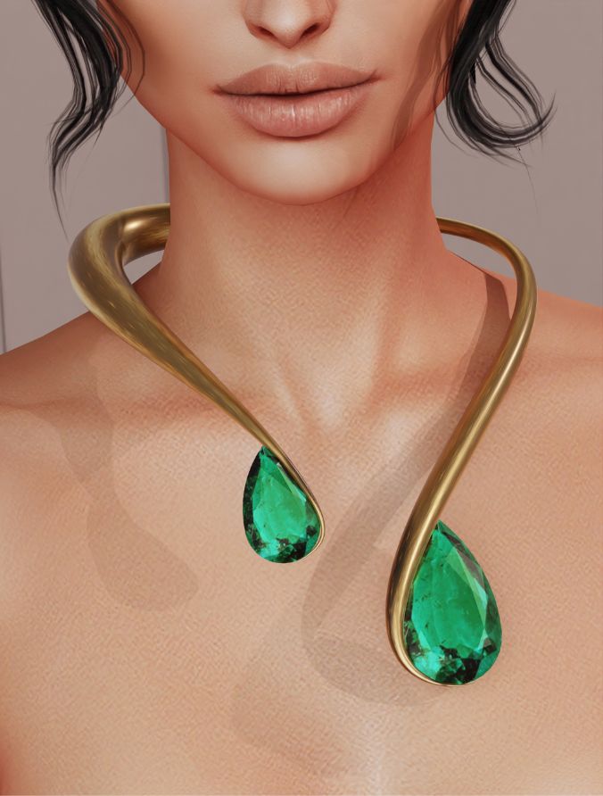 gold open necklace with large emeralds on both ends