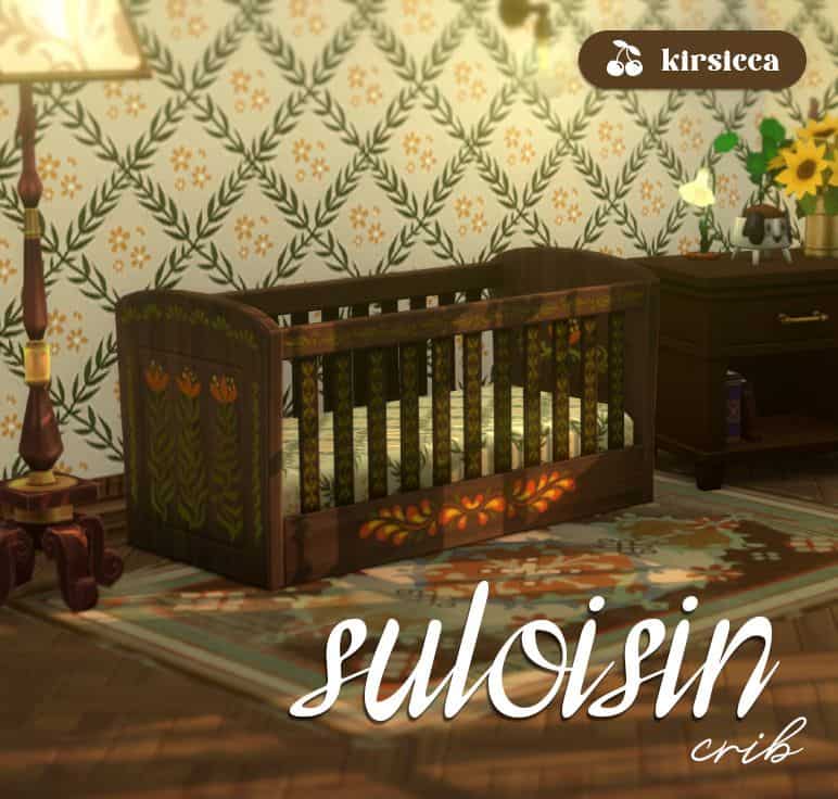 a dark wooden crib with floral design on the side
