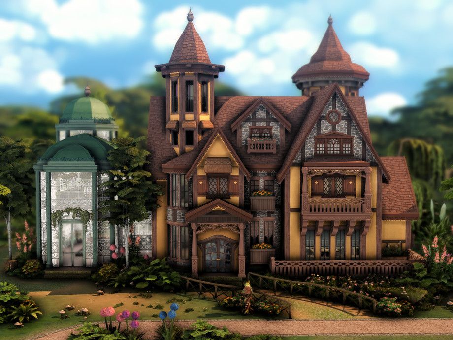a brown mansion with a large greenhouse on its side