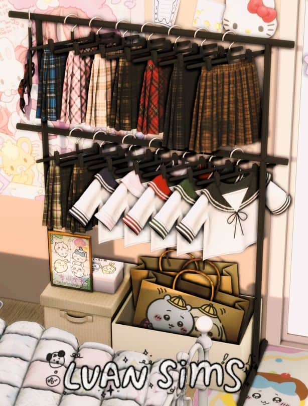 a freestanding clothing rack with hanging pleated skirts, tops and paper bags at the bottom