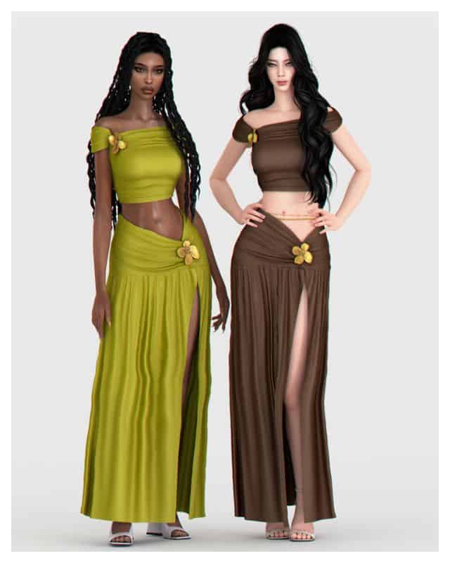 two female Sims wearing matching crop tops, maxi skirts with flower details