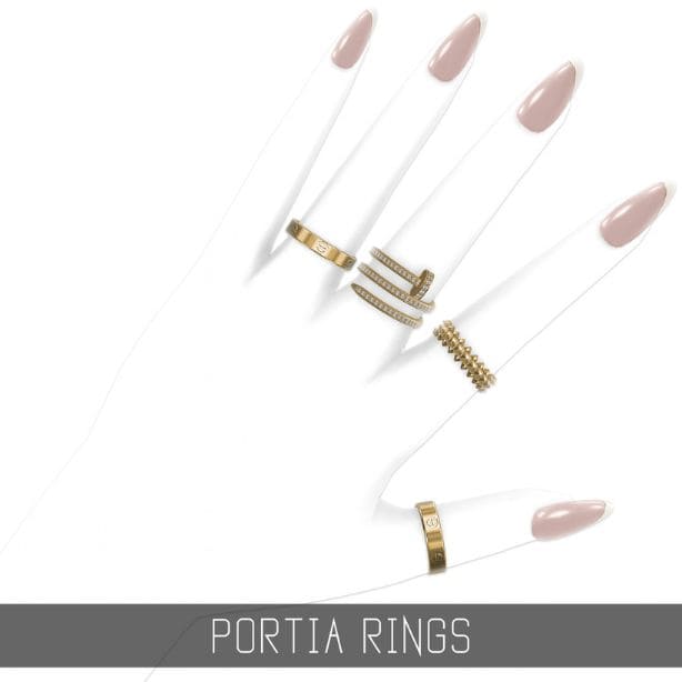 close up of different gold rings on a hand